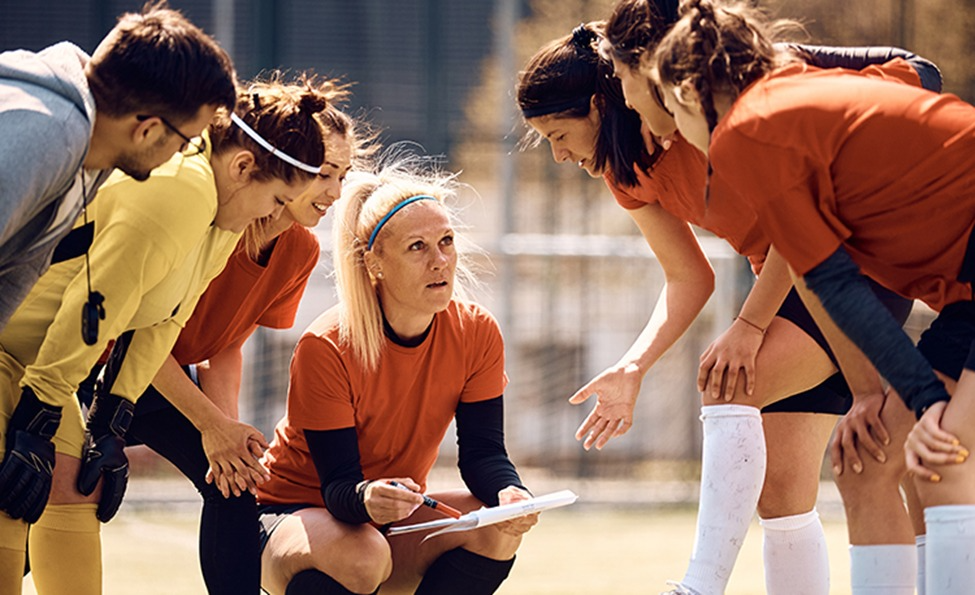 Coach briefing a team of student-athletes