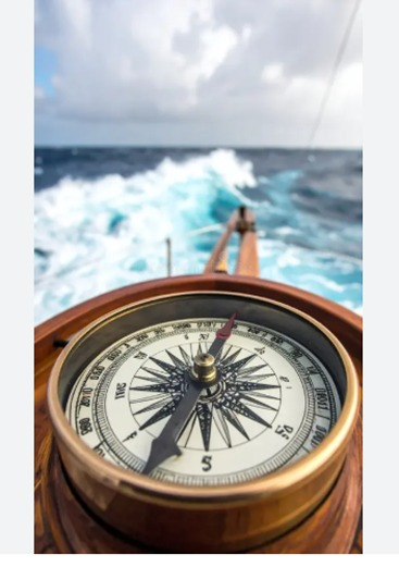 Nautical compass on a boat at sea