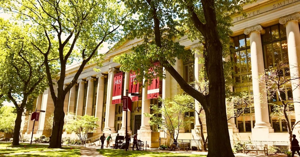 Historic university law school building on a leafy campus